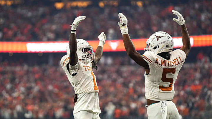 Texas Longhorns wide receivers Adonai Mitchell (5) and Xavier Worthy (1) celebrate a touchdown by Mitchell during the Big 12 Championship game against the Oklahoma State Cowboys at AT&T stadium on Saturday, Dec. 2, 2023 in Arlington. Texas Longhorns wide receivers Adonai Mitchell (5) and Xavier Worthy (1) celebrate a touchdown by Mitchell during the Big 12 Championship game against the Oklahoma State Cowboys at AT&T stadium on Saturday, Dec. 2, 2023 in Arlington.