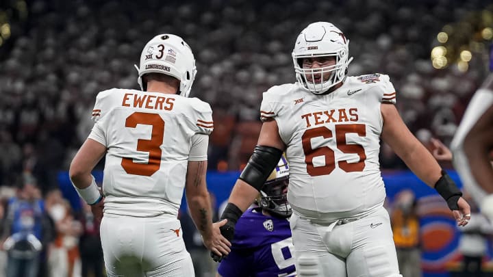 Texas Longhorns offensive lineman Jake Majors (65) celebrates a first down with quarterback Quinn Ewers (3) during the Sugar Bowl College Football Playoff semifinals game against the Washington Huskies at the Caesars Superdome on Monday, Jan. 1, 2024 in New Orleans, Louisiana. Texas Longhorns offensive lineman Jake Majors (65) celebrates a first down with quarterback Quinn Ewers (3) during the Sugar Bowl College Football Playoff semifinals game against the Washington Huskies at the Caesars Superdome on Monday, Jan. 1, 2024 in New Orleans, Louisiana.
