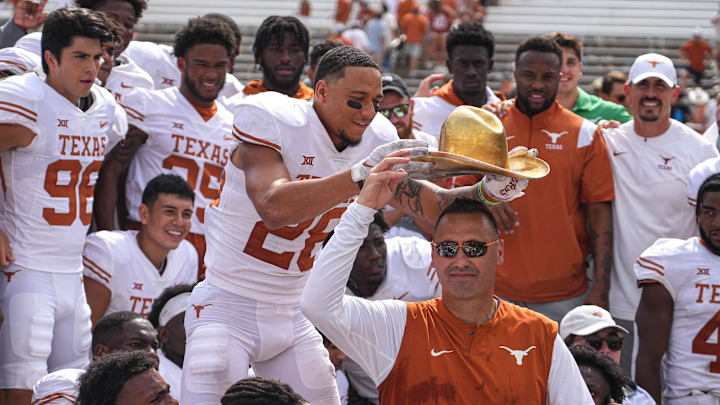 Oct 8, 2022; Dallas, Texas, USA: Texas Longhorns Longhorns defensive back Derrin Thompson (28) places the Golden Hat on the head of head coach Steve Sarkisian after a 49-0 victory over the Oklahoma Sooners in the annual Red River Showdown at the Cotton Bowl. Mandatory Credit: Aaron E. Martinez/Austin American-Statesman- USA TODAY NETWORK