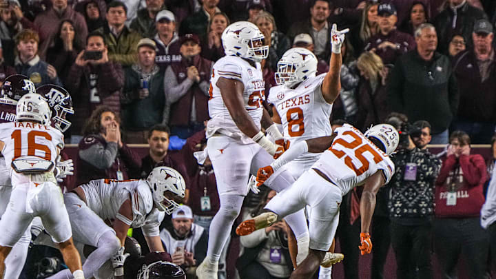 The Texas longhorns celebrate a stop on fourth and goal at the 1-yard line by edge rusher Ethan Burke (91) during the Lone Star Showdown at Kyle Field on Saturday, Nov. 30, 2024 in College Station, Texas.