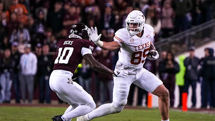 Texas Longhorns tight end Gunnar Helm (85) attempts to break a tackle by Texas A&M defensive back Dezz Ricks (10) during the Lone Star Showdown at Kyle Field on Saturday, Nov. 30, 2024 in College Station, Texas.
