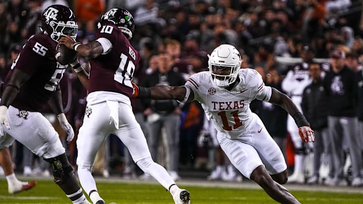 Nov 30, 2024; College Station, Texas, USA; Texas Longhorns edge rusher Colin Simmons (11) pressures Texas A&M quarterback Marcel Reed (10) during the Lone Star Showdown at Kyle Field. Mandatory Credit: Sara Diggins/USA TODAY Network via Imagn Images Nov 30, 2024; College Station, Texas, USA; Texas Longhorns edge rusher Colin Simmons (11) pressures Texas A&M quarterback Marcel Reed (10) during the Lone Star Showdown at Kyle Field. Mandatory Credit: Sara Diggins/USA TODAY Network via Imagn Images