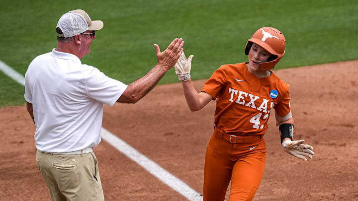 Texas Longhorns infielder Leighann Goode (43) high fives head coach Mike White at third after a home run during the NCAA D1 Softball Tournament Regional against UCF at Red and Charline McCombs Field on Sunday, May 18, 2025 in Austin, Texas. Texas Longhorns infielder Leighann Goode (43) high fives head coach Mike White at third after a home run during the NCAA D1 Softball Tournament Regional against UCF at Red and Charline McCombs Field on Sunday, May 18, 2025 in Austin, Texas.