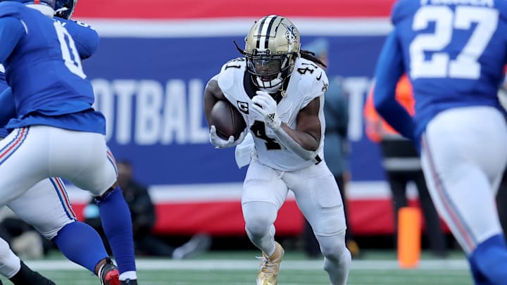 Dec 8, 2024; East Rutherford, New Jersey, USA; New Orleans Saints running back Alvin Kamara (41) runs with the ball against the New York Giants during the second quarter at MetLife Stadium. Mandatory Credit: Brad Penner-Imagn Images