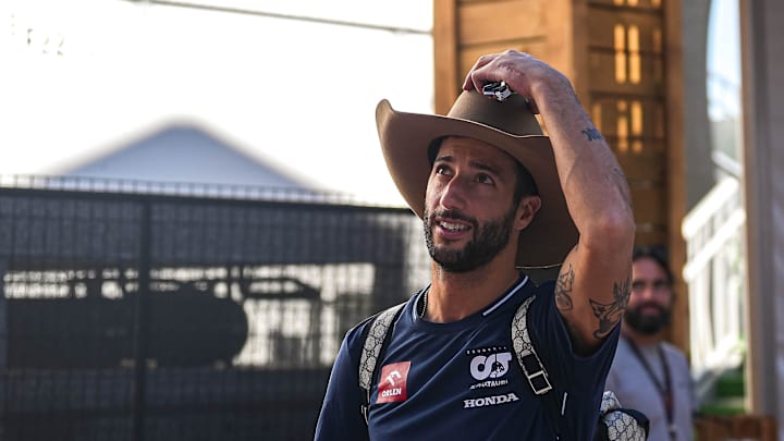 Scuderia AlphaTauri driver Daniel Ricciardo tips his hat to fans in the paddock area at Circuit of Scuderia AlphaTauri driver Daniel Ricciardo tips his hat to fans in the paddock area at Circuit of