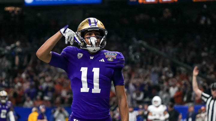 Washington wide receiver Jalen McMillan (11) mocks Texas fans with the \"horns down\" sign during the Sugar Bowl College Football Playoff  semifinals game against the Texas Longhorns at the Caesars Superdome on Monday, Jan. 1, 2024 in New Orleans, Louisiana.