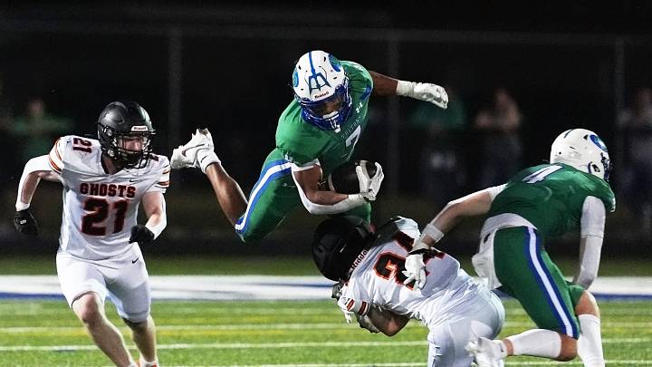 Green Bay Notre Dame's Kingston Allen (7) tries to leap over Kaukauna High School's Casen Vander Heiden (24) during a football game on Aug. 28, 2026, in Green Bay, Wis. Notre Dame defeated Kaukauna 35-28.