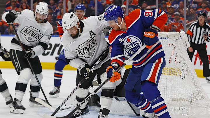 May 1, 2025; Edmonton, Alberta, CAN; Edmonton Oilers forward Corey Perry (90) battles with Los Angeles Kings defensemen Drew Doughty (8) for a loose puck during the first period in game six of the first round of the 2025 Stanley Cup Playoffs at Rogers Place. Mandatory Credit: Perry Nelson-Imagn Images