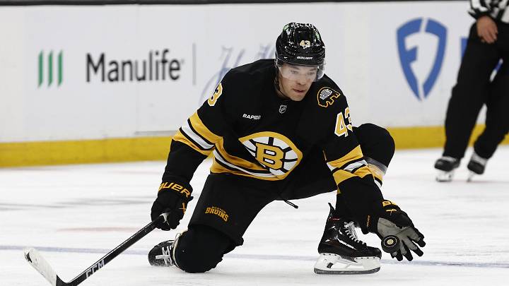 Oct 11, 2025; Boston, Massachusetts, USA; Boston Bruins defenseman Jordan Harris (43) reaches for a puck to keep it in the zone during the third period against the Buffalo Sabres at TD Garden. Mandatory Credit: Winslow Townson-Imagn Images