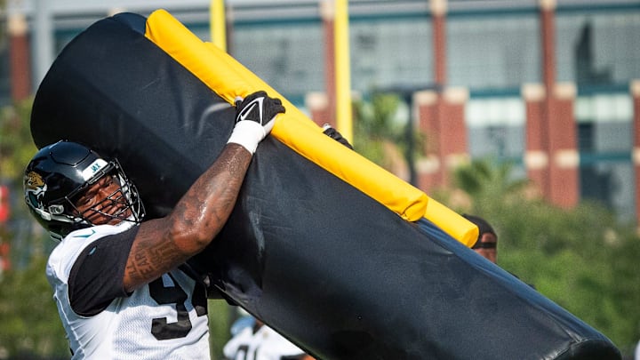 Jacksonville Jaguars defensive tackle Maason Smith (94) wraps up a tackling dummy during drills during the seventh organized team activity at the Miller Electric Center in Jacksonville, Fla. Monday, June 2, 2025. [Doug Engle/Florida Times-Union]