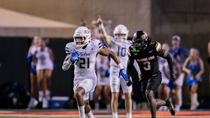 Sep 19, 2025; Stillwater, Oklahoma, USA; Tulsa Golden Hurricane running back Dominic Richardson (21) runs the ball past Oklahoma State Cowboys cornerback Cam Smith (3) during the second half at Boone Pickens Stadium. Mandatory Credit: William Purnell-Imagn Images