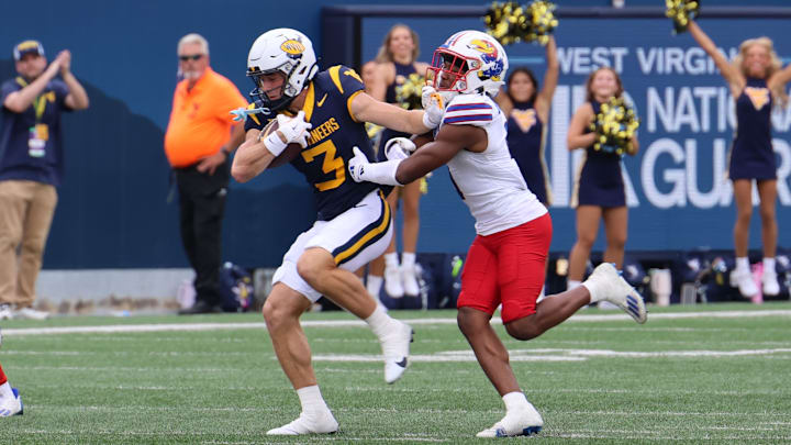 West Virginia University receiver Hudson Clement escapes the grasp of Kansas safety O.J. Burroughs for a 38-yard reception. West Virginia University receiver Hudson Clement escapes the grasp of Kansas safety O.J. Burroughs for a 38-yard reception.
