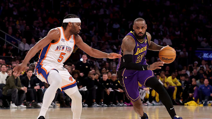 Feb 1, 2025; New York, New York, USA; Los Angeles Lakers forward LeBron James (23) brings the ball up court against New York Knicks forward Precious Achiuwa (5) during the third quarter at Madison Square Garden. Mandatory Credit: Brad Penner-Imagn Images