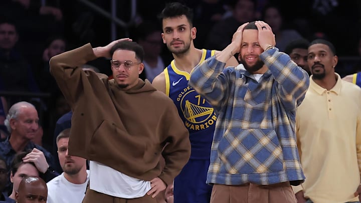 Mar 15, 2026; New York, New York, USA; Golden State Warriors guards Seth Curry (31) and Stephen Curry (30) react from the bench during the fourth quarter against the New York Knicks at Madison Square Garden. Mandatory Credit: Brad Penner-Imagn Images