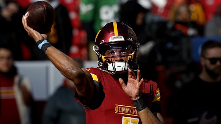 Dec 22, 2024; Landover, Maryland, USA; Washington Commanders quarterback Jayden Daniels (5) passes the ball during warmup prior to the game against the Philadelphia Eagles at Northwest Stadium. Mandatory Credit: Geoff Burke-Imagn Images