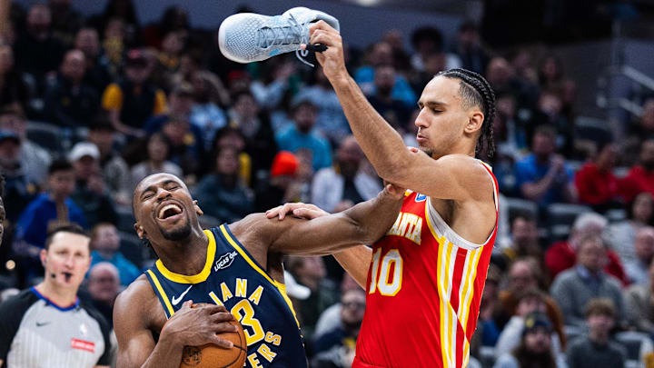Jan 31, 2026; Indianapolis, Indiana, USA; Indiana Pacers guard/forward Aaron Nesmith (23) dribbles the ball while Atlanta Hawks forward Zaccharie Risacher (10) defends in the first half at Gainbridge Fieldhouse. Mandatory Credit: Trevor Ruszkowski-Imagn Images