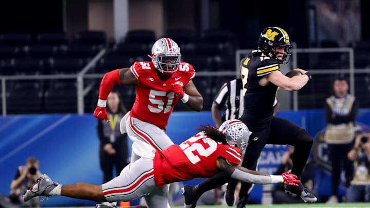 Dec 29, 2023; Arlington, TX, USA;  Ohio State Buckeyes linebacker Steele Chambers (22) tackles Missouri Tigers quarterback Brady Cook (12) during the first half at AT&T Stadium. Mandatory Credit: Kevin Jairaj-USA TODAY Sports