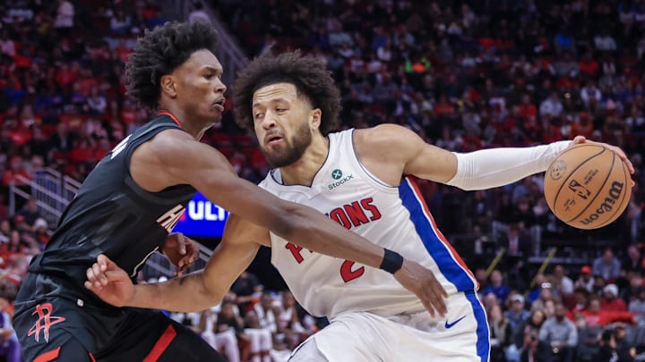 Jan 20, 2025; Houston, Texas, USA;  Detroit Pistons guard Cade Cunningham (2) dribbles against Houston Rockets forward Amen Thompson (1) in the second half at Toyota Center. Mandatory Credit: Thomas Shea-Imagn Images