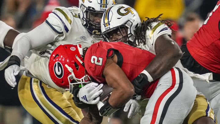 Nov 25, 2023; Atlanta, Georgia, USA; Georgia Tech Yellow Jackets defensive lineman Zeek Biggers (88) tackles Georgia Bulldogs running back Kendall Milton (2) during the second half at Hyundai Field. Mandatory Credit: Dale Zanine-USA TODAY Sports
