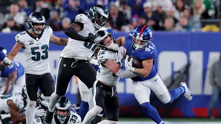 Oct 9, 2025; East Rutherford, New Jersey, USA; New York Giants running back Cam Skattebo (44) runs with the ball against Philadelphia Eagles safety Reed Blankenship (32) and defensive tackle Moro Ojomo (97) during the fourth quarter at MetLife Stadium. Oct 9, 2025; East Rutherford, New Jersey, USA; New York Giants running back Cam Skattebo (44) runs with the ball against Philadelphia Eagles safety Reed Blankenship (32) and defensive tackle Moro Ojomo (97) during the fourth quarter at MetLife Stadium.