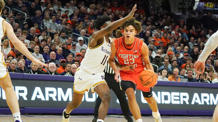 Jan 14, 2026; Evanston, Illinois, USA; Northwestern Wildcats guard Jordan Clayton (11) defends Illinois Fighting Illini guard Keaton Wagler (23) during the first half at Welsh-Ryan Arena. Mandatory Credit: David Banks-Imagn Images