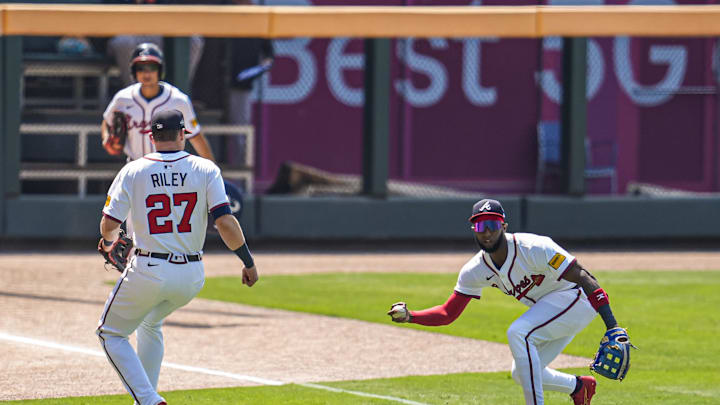 Jul 6, 2025; Cumberland, Georgia, USA; A ball hit by Baltimore Orioles second baseman Jackson Holliday (7) (not pictured) drops for a hit between Atlanta Braves third baseman Austin Riley (27) and left fielder Jurickson Profar (7) during the first inning at Truist Park. Mandatory Credit: Dale Zanine-Imagn Images