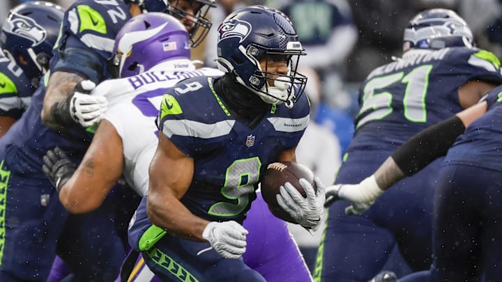 Dec 22, 2024; Seattle, Washington, USA; Seattle Seahawks running back Kenneth Walker III (9) rushes against the Minnesota Vikings during the first quarter at Lumen Field. Mandatory Credit: Joe Nicholson-Imagn Images