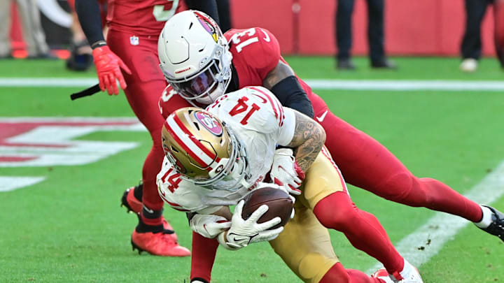 Jan 5, 2025; Glendale, Arizona, USA; San Francisco 49ers wide receiver Ricky Pearsall (14) scores a touchdown  while being tackled by Arizona Cardinals cornerback Kei'Trel Clark (13) in the first half at State Farm Stadium. Mandatory Credit: Matt Kartozian-Imagn Images