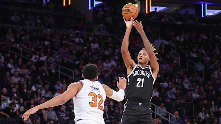 Nov 9, 2025; New York, New York, USA;  Brooklyn Nets forward Noah Clowney (21) shoots past New York Knicks center Karl-Anthony Towns (32) in the fourth quarter at Madison Square Garden. Mandatory Credit: Wendell Cruz-Imagn Images