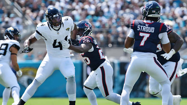 Houston Texans running back Devin Singletary (26) tries to hold back Jacksonville Jaguars linebacker Travon Walker (44) as he tries to get to Texans quarterback C.J. Stroud (7) during first quarter action. The Jacksonville Jaguars hosted the Houston Texans at EverBank Stadium in Jacksonville, Fla. Sunday, September 24, 2023. The Jaguars trailed 17 to 0 at the end of the first half. [Bob Self/Florida Times-Union]