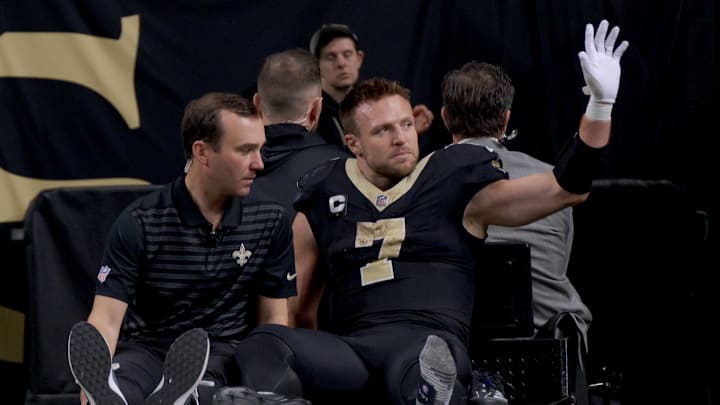 Dec 1, 2024; New Orleans, Louisiana, USA; New Orleans Saints tight end Taysom Hill (7) leaves the field after an injury against the Los Angeles Rams during the second half at Caesars Superdome. Mandatory Credit: Matthew Hinton-Imagn Images