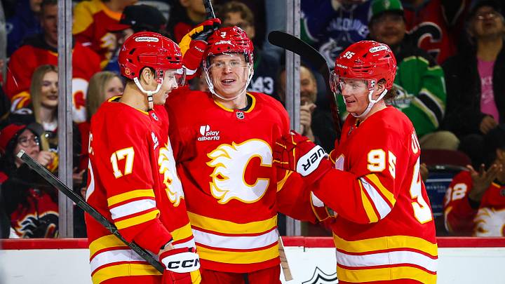 Mar 28, 2026; Calgary, Alberta, CAN; Calgary Flames defenseman Olli Maatta (3) celebrates his goal with teammates against the Vancouver Canucks during the second period at Scotiabank Saddledome. Mandatory Credit: Sergei Belski-Imagn Images