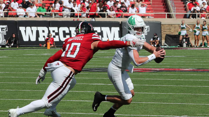 Sep 14, 2024; Lubbock, Texas, USA; Texas Tech Red Raiders defensive back Jacob Rodriquez (10) pressures North Texas Mean Green quarterback Chandler Morris (4) in the first half at Jones AT&T Stadium and Cody Campbell Field. Mandatory Credit: Michael C. Johnson-Imagn Images Sep 14, 2024; Lubbock, Texas, USA; Texas Tech Red Raiders defensive back Jacob Rodriquez (10) pressures North Texas Mean Green quarterback Chandler Morris (4) in the first half at Jones AT&T Stadium and Cody Campbell Field. Mandatory Credit: Michael C. Johnson-Imagn Images