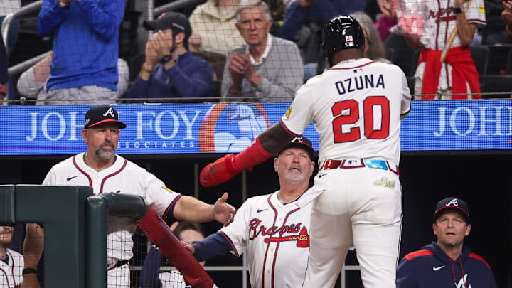 May 7, 2025; Atlanta, Georgia, USA; Atlanta Braves designated hitter Marcell Ozuna (20) celebrates with bench coach Walt Weiss (4) and manager Brian Snitker (43) after scoring a run against the Cincinnati Reds in the sixth inning at Truist Park. Mandatory Credit: Brett Davis-Imagn Images
