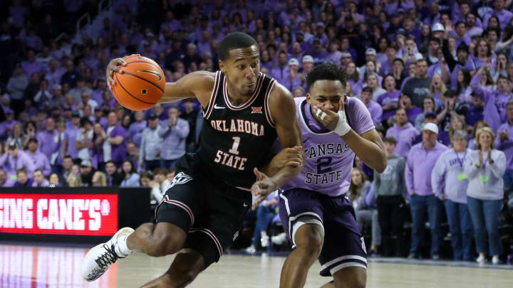 Jan 20, 2024; Manhattan, Kansas, USA; Oklahoma State Cowboys guard Bryce Thompson (1) dibbles by Kansas State Wildcats guard Tylor Perry (2) during the second half at Bramlage Coliseum. Mandatory Credit: Scott Sewell-USA TODAY Sports