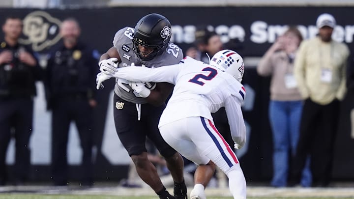 Nov 1, 2025; Boulder, Colorado, USA; Arizona Wildcats defensive back Treydan Stukes (2) tackles Colorado Buffaloes running back Micah Welch (29) at Folsom Field. Mandatory Credit: Ron Chenoy-Imagn Images
