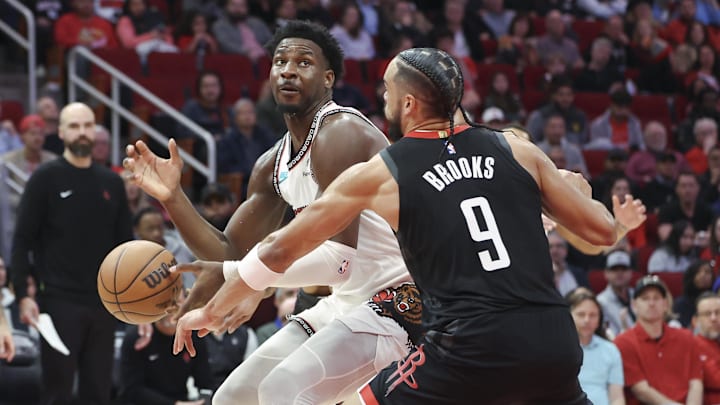 Jan 13, 2025; Houston, Texas, USA; Houston Rockets forward Dillon Brooks (9) attempts to steal the ball from Memphis Grizzlies forward Jaren Jackson Jr. (13) during the second quarter at Toyota Center. Mandatory Credit: Troy Taormina-Imagn Images