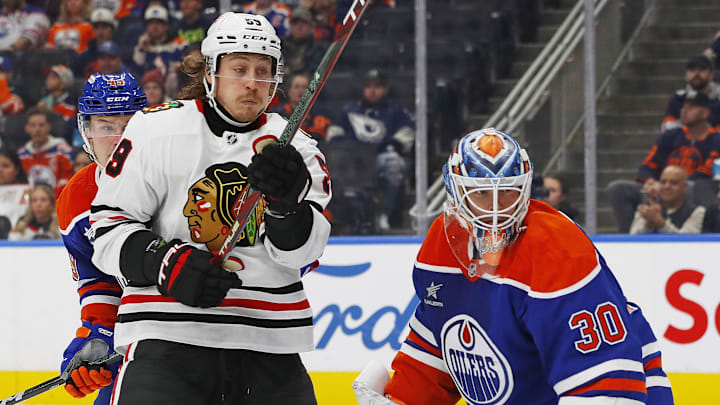 Oct 12, 2024; Edmonton, Alberta, CAN; Chicago Blackhawks forward Tyler Bertuzzi (59) and Edmonton Oilers goaltender Calvin Pickard (30) look for a loose puck during the second period at Rogers Place. Mandatory Credit: Perry Nelson-Imagn Images