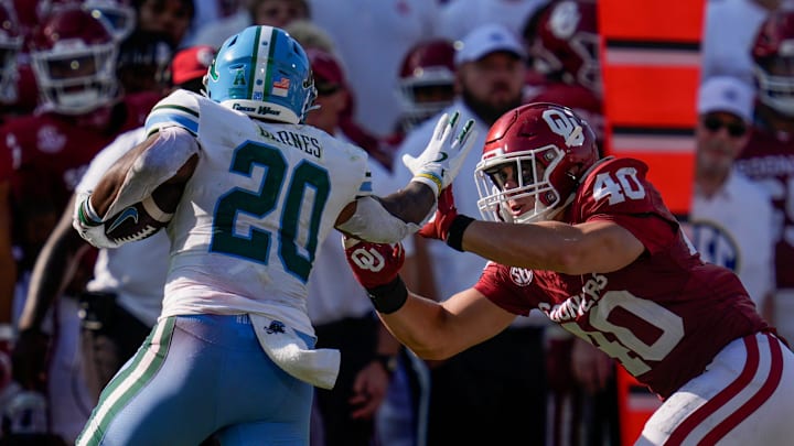 Oklahoma Sooners defensive lineman chases after Tulane Green Wave running back Arnold Barnes III (20) during a college football game between the University of Oklahoma Sooners (OU) and the Tulane Green Wave at Gaylord Family 