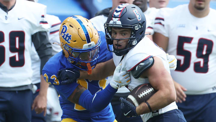 Aug 30, 2025; Pittsburgh, Pennsylvania, USA; Duquesne Dukes wide receiver Joey Isabella (5) runs after a catch against Pittsburgh Panthers defensive back Davion Pritchard (23) during the third quarter at Acrisure Stadium. Mandatory Credit: Charles LeClaire-Imagn Images