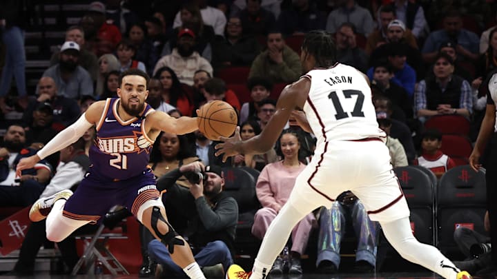 Feb 12, 2025; Houston, Texas, USA; Phoenix Suns guard Tyus Jones (21) steals the ball from Houston Rockets forward Tari Eason (17) in the first quarter at Toyota Center. Mandatory Credit: Thomas Shea-Imagn Images
