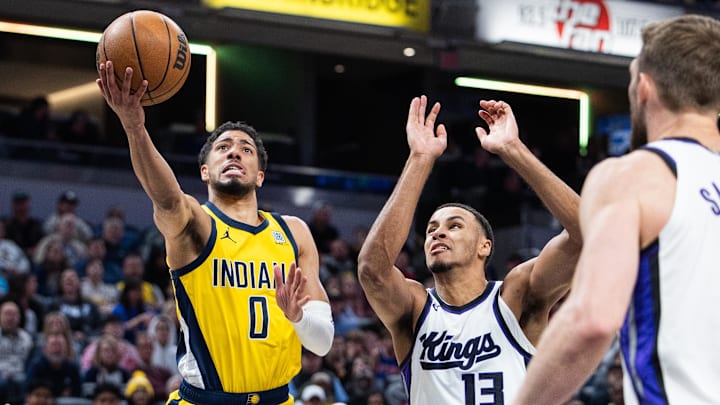 Mar 31, 2025; Indianapolis, Indiana, USA; Indiana Pacers guard Tyrese Haliburton (0) shoots the ball while Sacramento Kings forward Keegan Murray (13)  defends in the first half at Gainbridge Fieldhouse. Mandatory Credit: Trevor Ruszkowski-Imagn Images