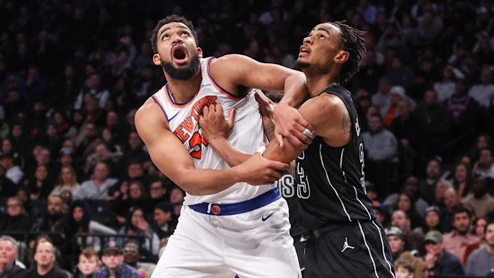 Jan 21, 2025; Brooklyn, New York, USA;  New York Knicks center Karl-Anthony Towns (32) and Brooklyn Nets center Nic Claxton (33) box out for a rebound in the fourth quarter at Barclays Center. Mandatory Credit: Wendell Cruz-Imagn Images