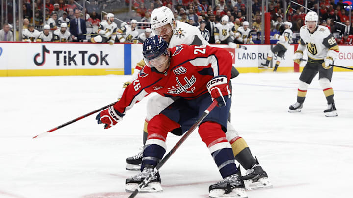 Oct 15, 2024; Washington, District of Columbia, USA; Washington Capitals center Nic Dowd (26) skates with the puck as Vegas Golden Knights center Tomas Hertl (48) defends in the third period at Capital One Arena. Mandatory Credit: Geoff Burke-Imagn Images