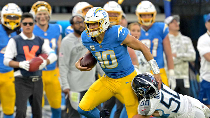 Nov 10, 2024; Inglewood, California, USA; Los Angeles Chargers quarterback Justin Herbert (10) runs for a first down before he is stopped by Tennessee Titans linebacker Jack Gibbens (50) in the second half at SoFi Stadium. Nov 10, 2024; Inglewood, California, USA; Los Angeles Chargers quarterback Justin Herbert (10) runs for a first down before he is stopped by Tennessee Titans linebacker Jack Gibbens (50) in the second half at SoFi Stadium.