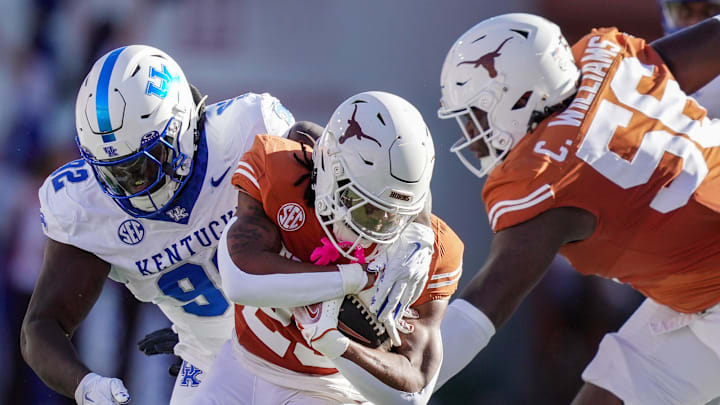 Texas Longhorns running back Jaydon Blue (23) fights for yardage against Kentucky Wildcats defensive lineman Kahlil Saunders (92) in the first quarter during the first half of an NCAA college football game at Darrell K Royal Texas Memorial Stadium, Austin, Texas, Saturday, Nov 24, 2024.