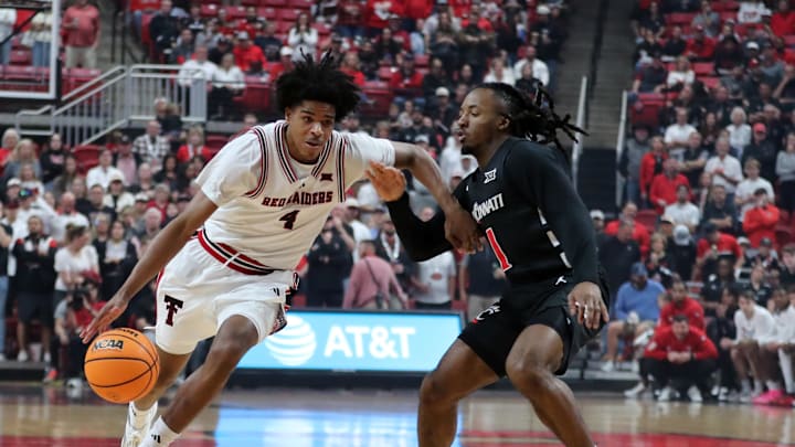 Feb 24, 2026; Lubbock, Texas, USA; Texas Tech Red Raiders guard Christian Anderson (4) drives around Cincinnati Bearcats guard Day Day Thomas (1) in the first half at United Supermarkets Arena. Mandatory Credit: Michael C. Johnson-Imagn Images Feb 24, 2026; Lubbock, Texas, USA; Texas Tech Red Raiders guard Christian Anderson (4) drives around Cincinnati Bearcats guard Day Day Thomas (1) in the first half at United Supermarkets Arena. Mandatory Credit: Michael C. Johnson-Imagn Images