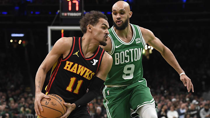 Feb 7, 2024; Boston, Massachusetts, USA;  Atlanta Hawks guard Trae Young (11) controls the ball while Boston Celtics guard Derrick White (9) defends during the first half at TD Garden. Mandatory Credit: Bob DeChiara-Imagn Images