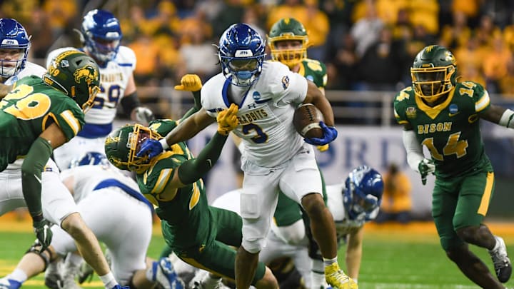 South Dakota State Jackrabbits running back Amar Johnson (3) stiff-arms North Dakota State Bison cornerback Kegan Huber.
