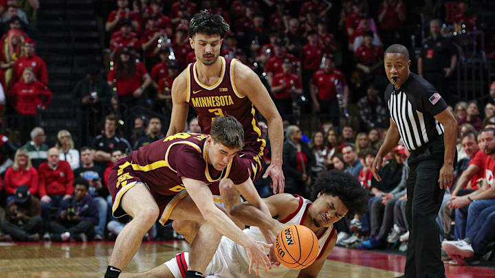 Mar 9, 2025; Piscataway, New Jersey, USA; Rutgers Scarlet Knights guard Dylan Harper (2) and Minnesota Golden Gophers guard Brennan Rigsby (24) battle for the ball in front of forward Dawson Garcia (3) during the first half at Jersey Mike's Arena. Mandatory Credit: Vincent Carchietta-Imagn Images